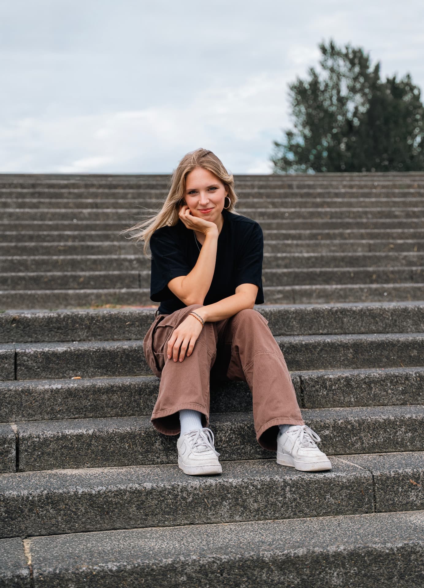 Tia Bizjak Holc sitting on outdoor steps